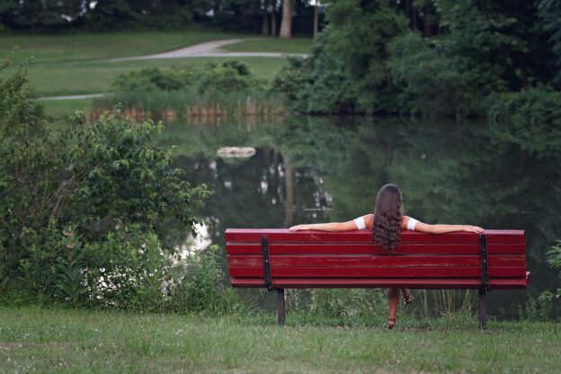 photography of woman relaxing on bench
